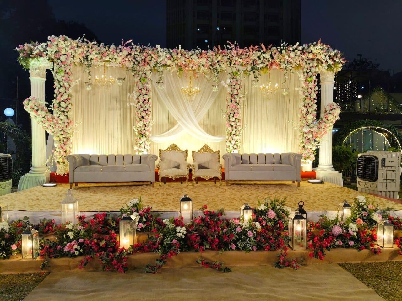 Classic floral wedding stage illuminated with warm lights